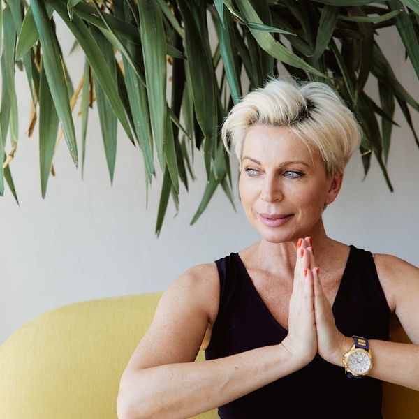 Person sitting peacefully in a calm environment, looking refreshed after a workout session.